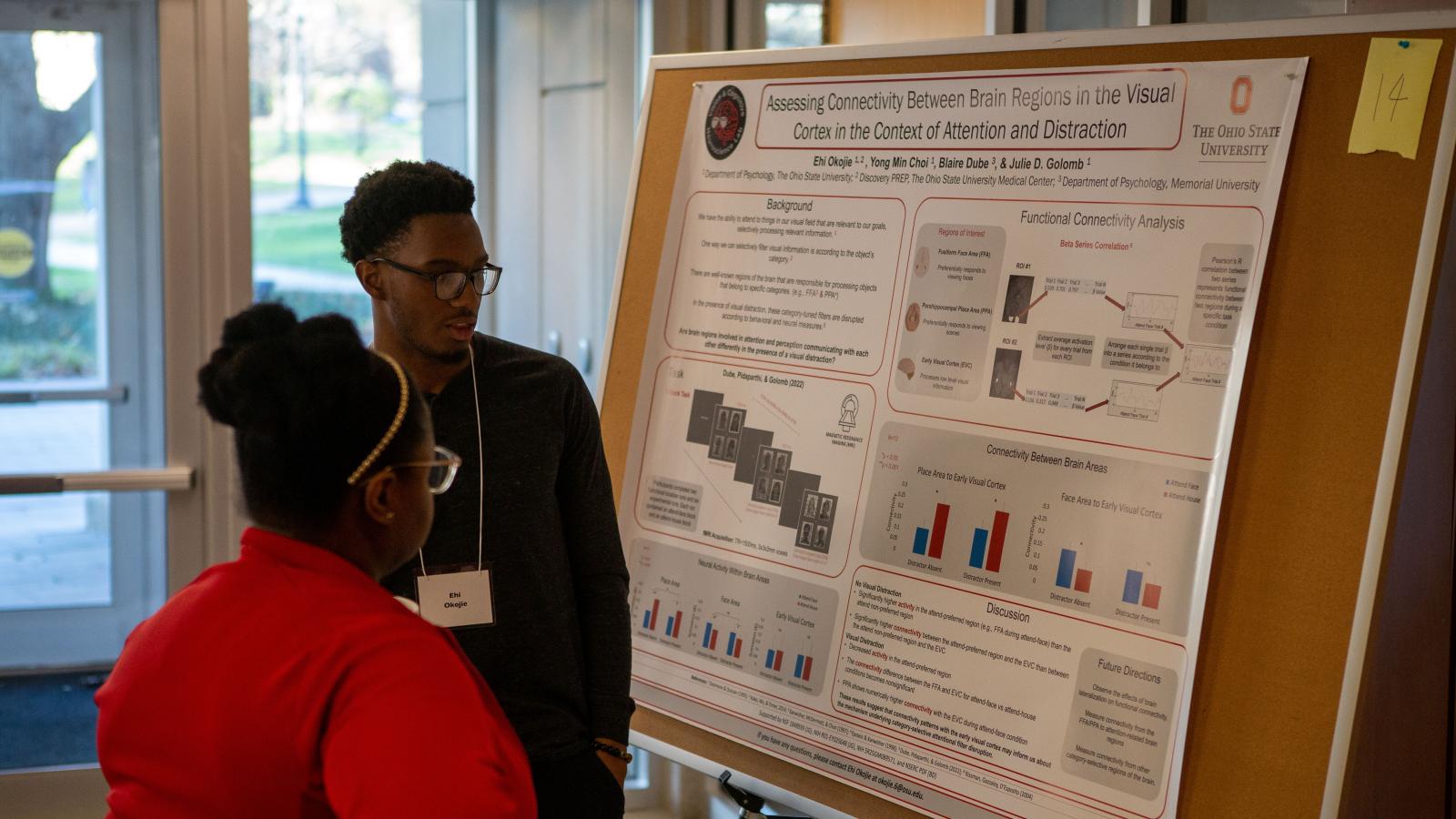 Research Day participants discussing poster presentation