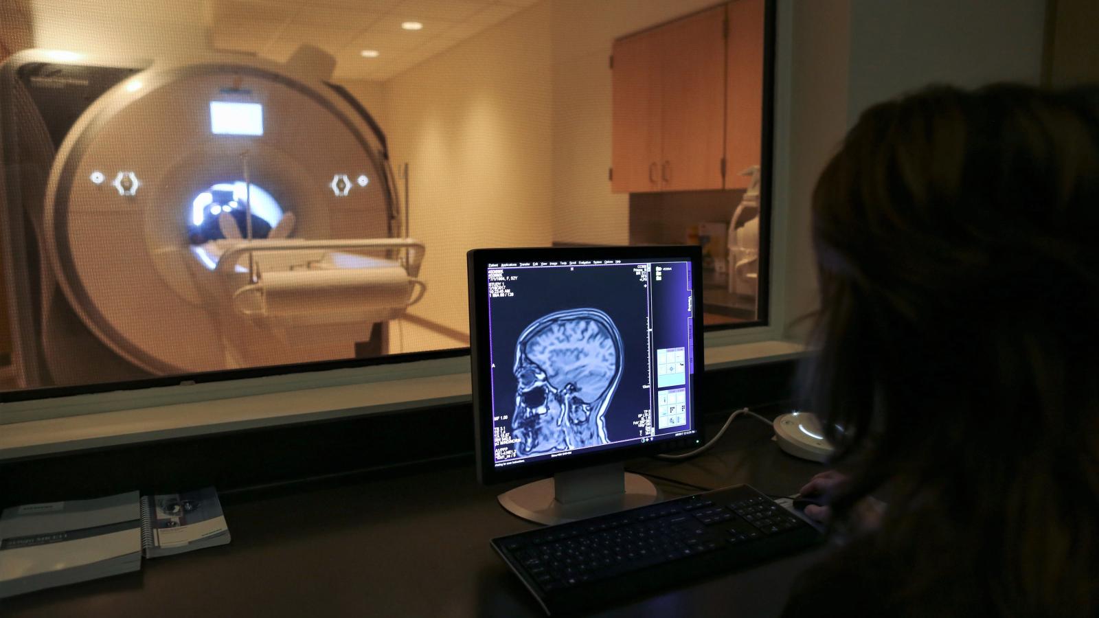 fMRI Technologist shows brain image at safety training